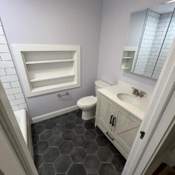 New bathroom with tiling and updated furnishings