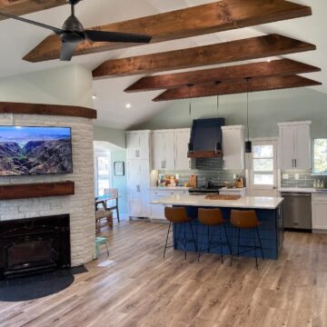 New living room with vaulted ceilings and exposed beams